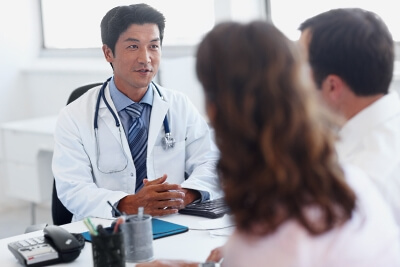 Doctor talking to couple