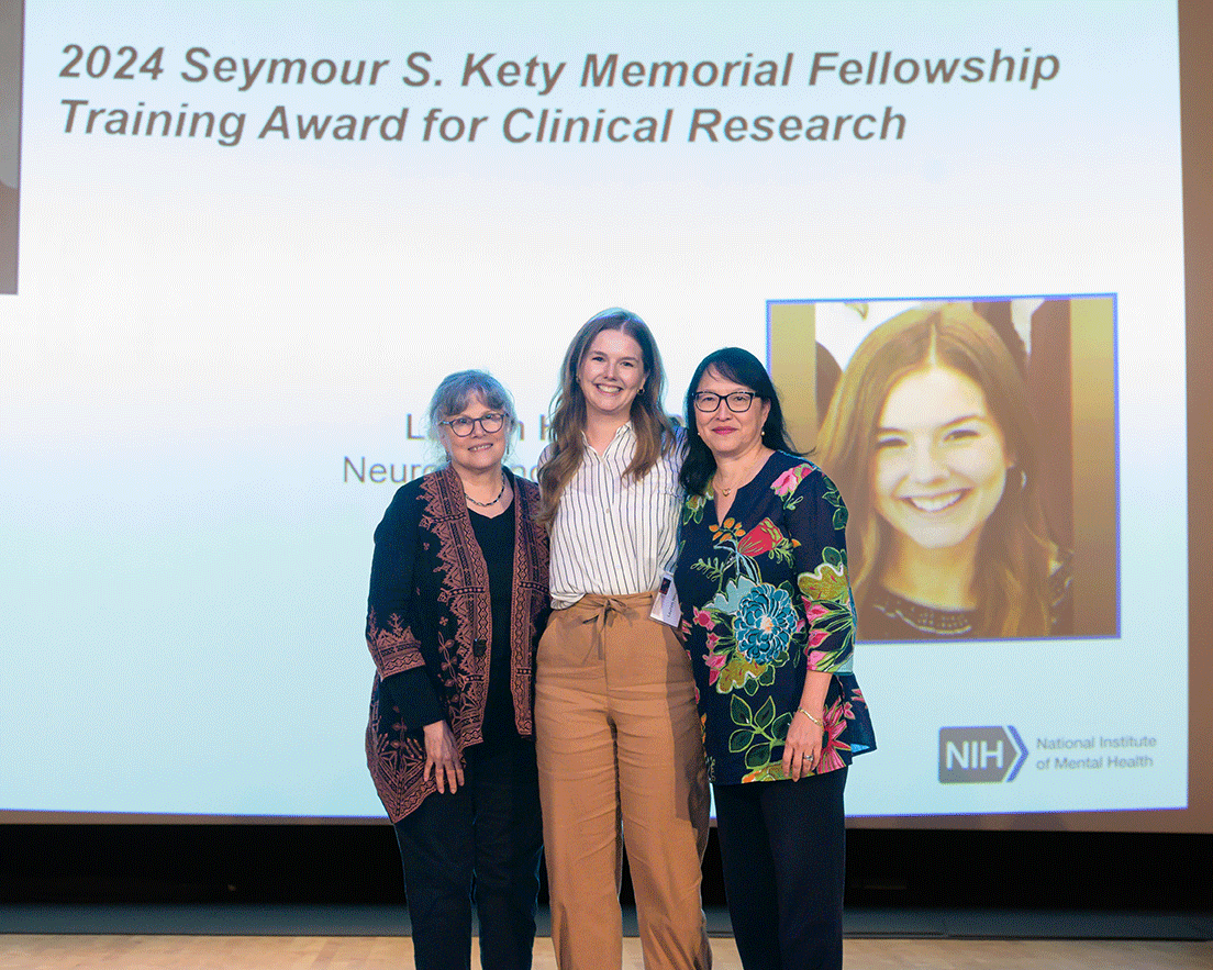 Lauren Henry poses for a photo with two other people.