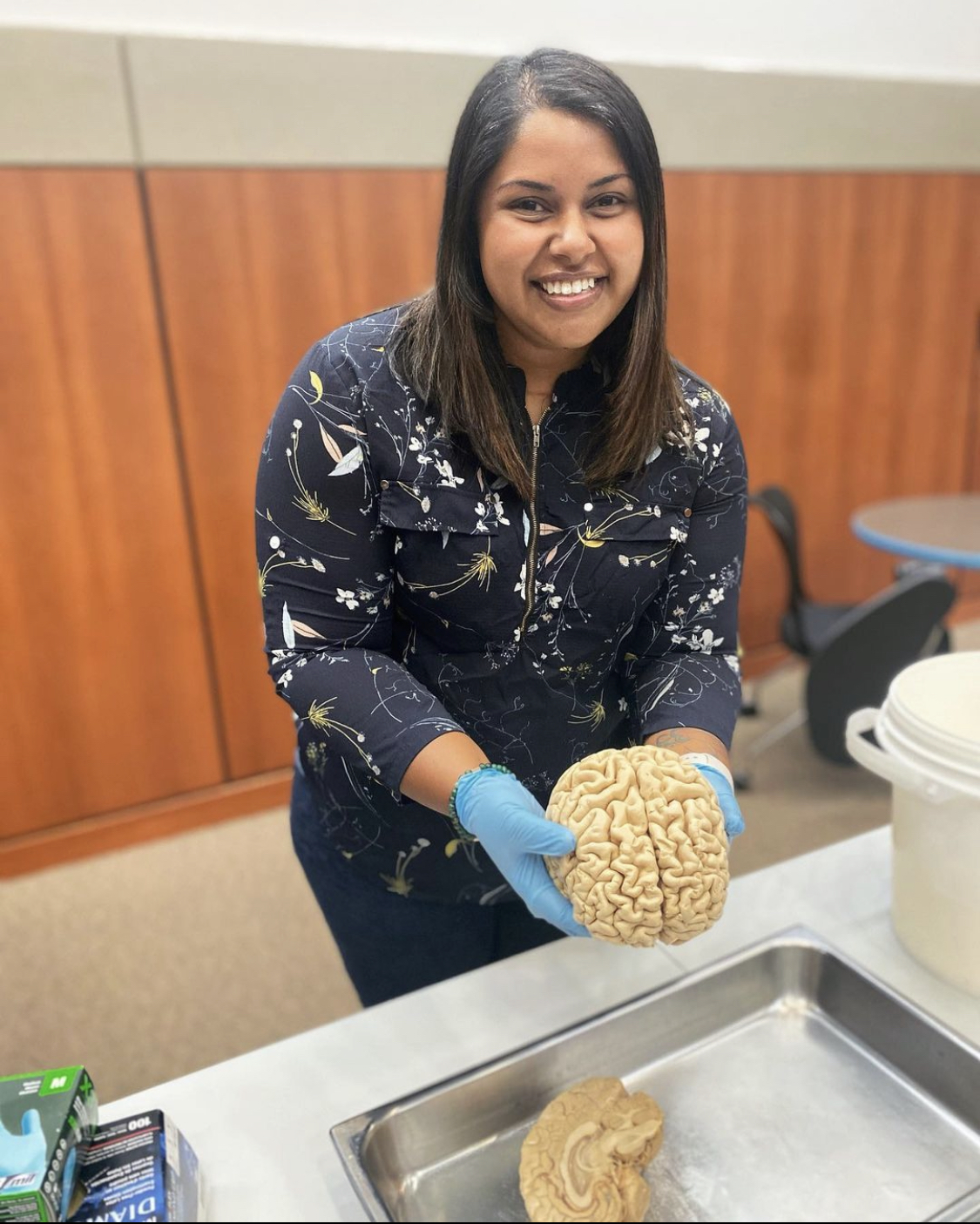 Uma Chatterjee holding a preserved human brain