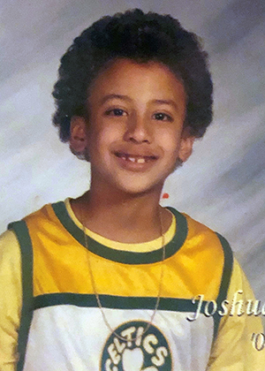 A childhood photo of Josh Santana wearing a Boston Celtics jersey.