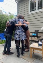Lab members share a group hug at end of year party