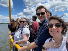 Mandy, Corey Plate, Corey Ziemba, and Dr. Lopez-Guzman smiling on a water taxi on the Potomac river.